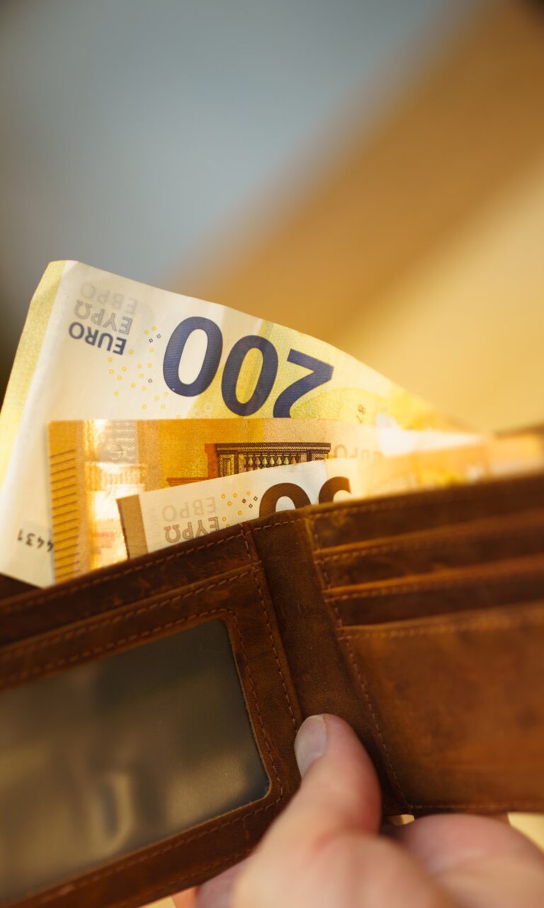 Portefeuille en cuir fermé posé sur une surface claire, en gros plan